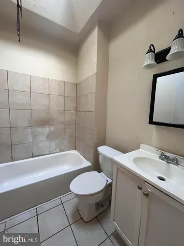 a bathroom with a toilet a sink and bathtub
