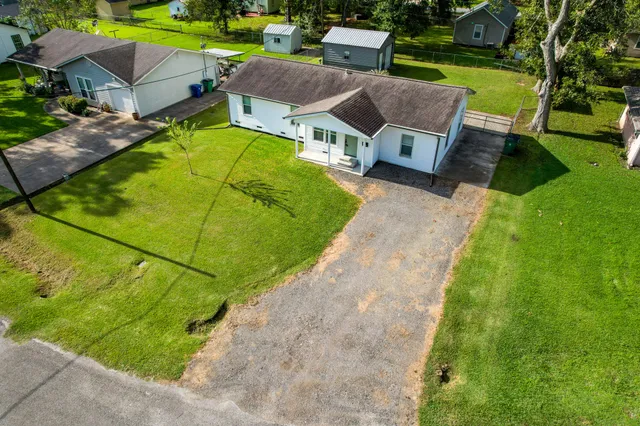 an aerial view of a house with garden space and street view