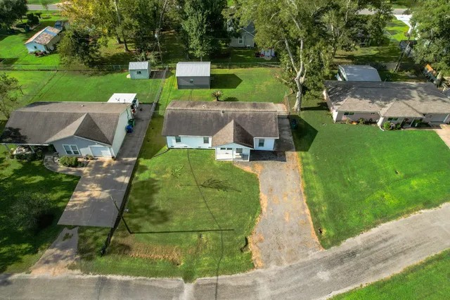 an aerial view of a house with garden space and street view