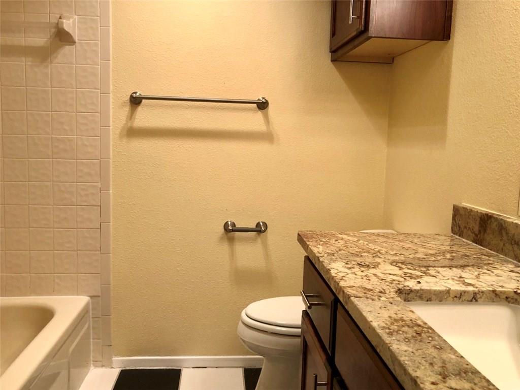 806 West 24th Street, Unit 107 Austin, TX 78705 - Photo 7 of 7 a bathroom with a granite countertop sink toilet and shower