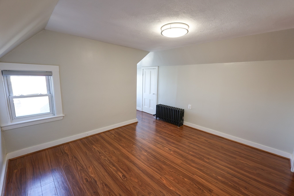 369 Savin Hill Avenue, Unit 3 Boston, MA 02125 - Photo 16 of 16 an empty room with wooden floor and windows
