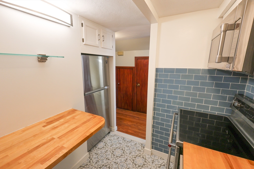 369 Savin Hill Avenue, Unit 3 Boston, MA 02125 - Photo 2 of 16 a bathroom with a bathtub and a shower