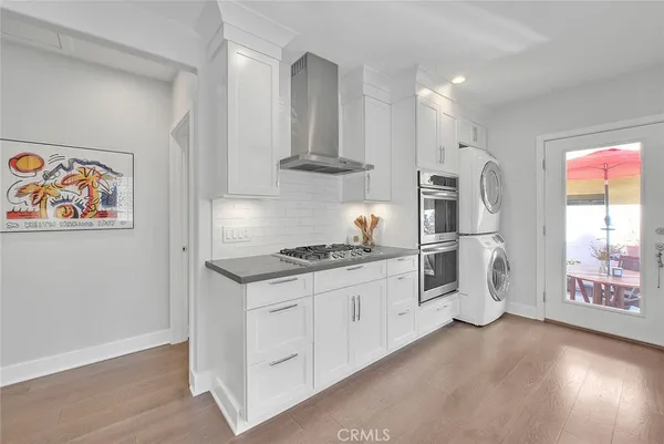 a kitchen with stainless steel appliances granite countertop a stove and a refrigerator