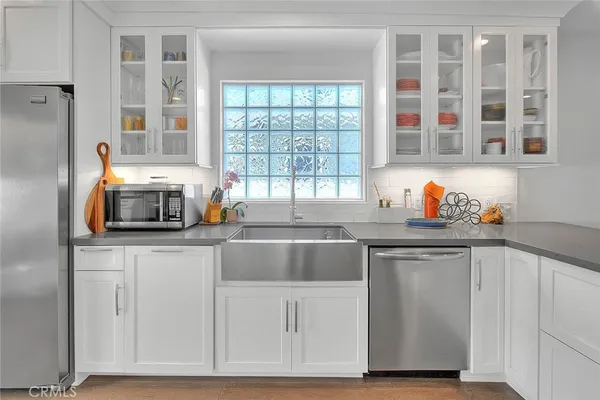 a kitchen with stainless steel appliances granite countertop a stove and a sink
