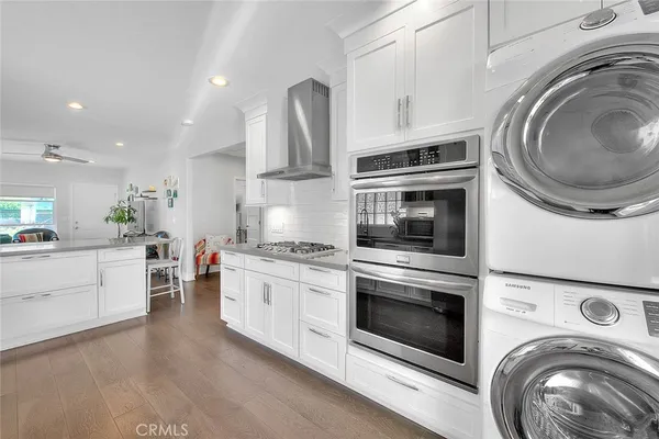 a kitchen with granite countertop a washer and dryer