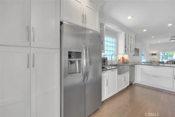 a kitchen with stainless steel appliances a refrigerator sink and cabinets