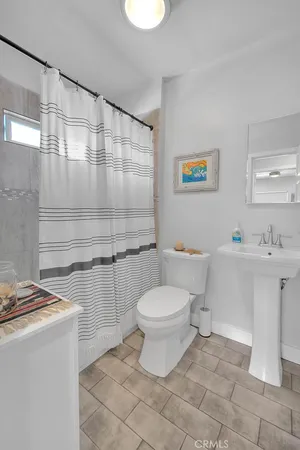 a bathroom with a sink a toilet and a shower