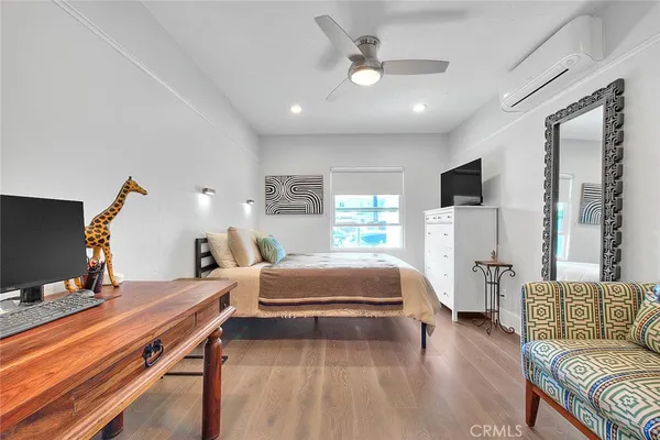 a bedroom with furniture and a wooden floor