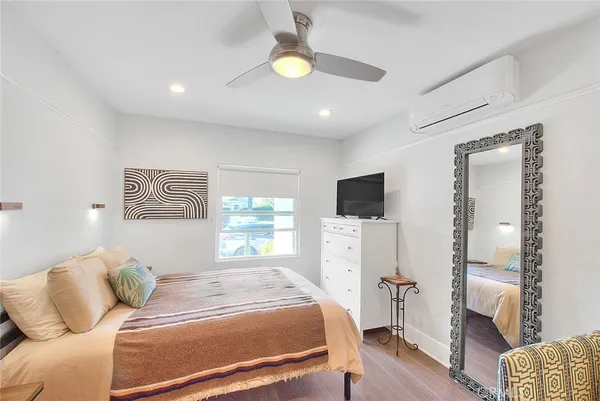 a bedroom with a bed and flat screen tv