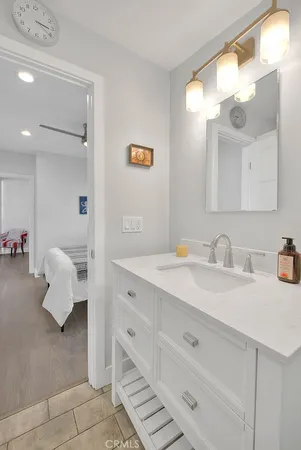 a bathroom with a sink vanity and mirror