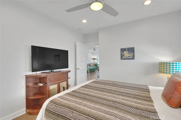 a bedroom with a bed and a flat screen tv