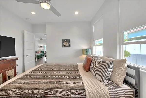 a bedroom with a large bed and a flat screen tv