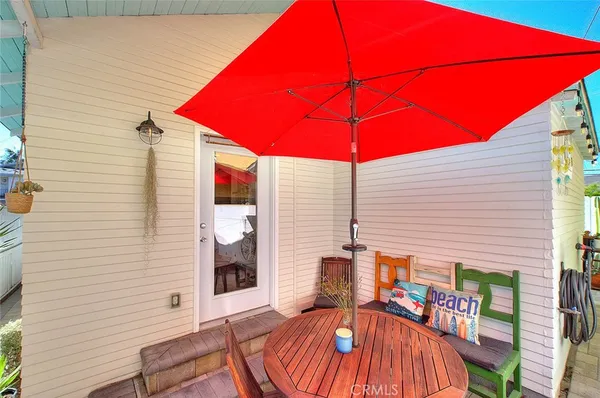 a view of a balcony with chairs and a umbrella