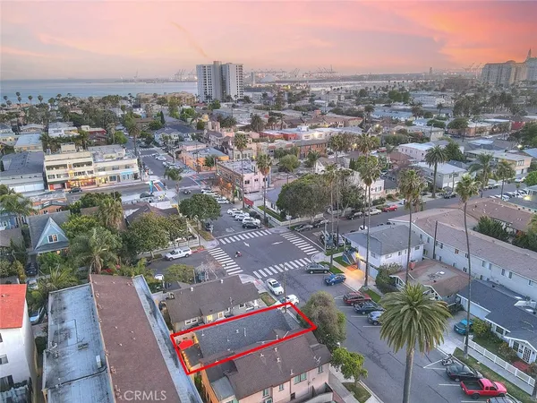 an aerial view of residential houses with outdoor space and trees
