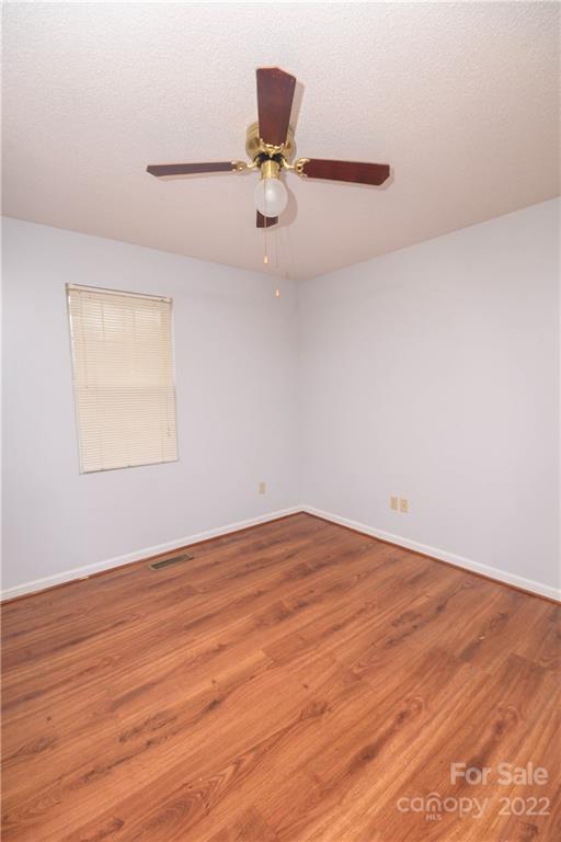 696 Forest Road Rock Hill, SC 29730 - Photo 3 of 15 wooden floor in an empty room with a window