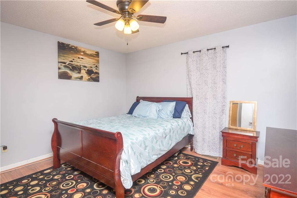 696 Forest Road Rock Hill, SC 29730 - Photo 6 of 15 a bedroom with a bed and a chandelier