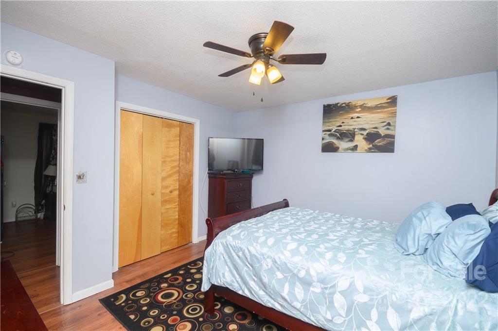 696 Forest Road Rock Hill, SC 29730 - Photo 7 of 15 a bedroom with a bed and a chandelier