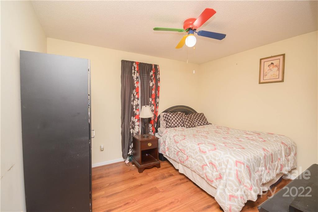 696 Forest Road Rock Hill, SC 29730 - Photo 8 of 15 a bedroom with a bed and a chandelier