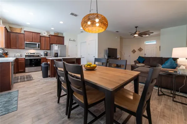 a view of a dining room with furniture and wooden floor
