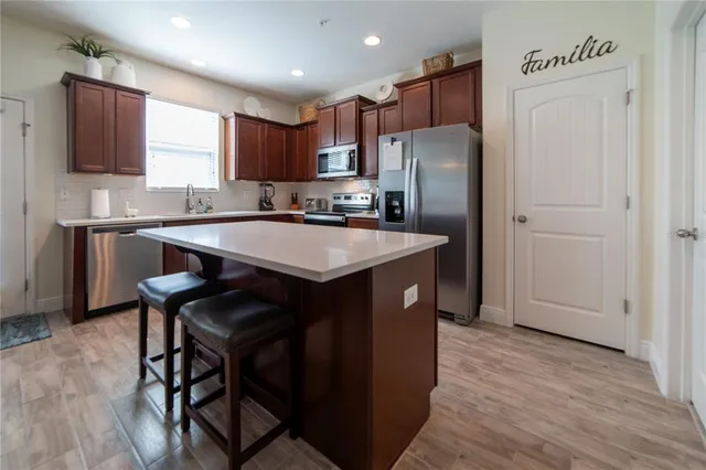 a kitchen with refrigerator cabinets and wooden floor
