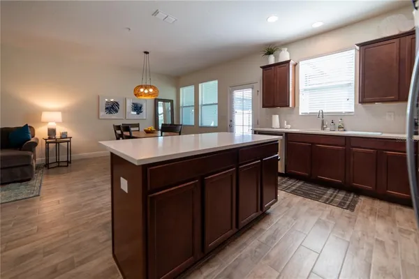 a kitchen with a sink stove and wooden cabinets