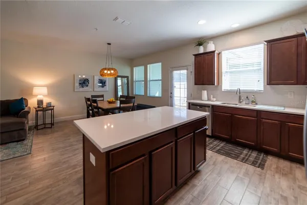a kitchen with a sink stove and wooden cabinets
