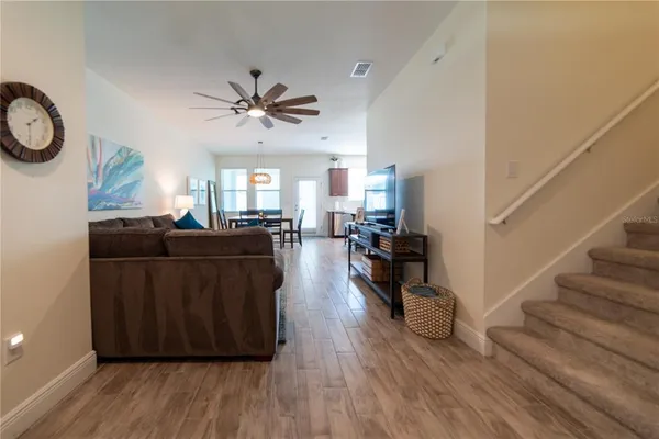 a living room with furniture and a wooden floor