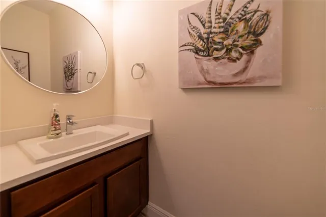 a bathroom with a sink a mirror and vanity