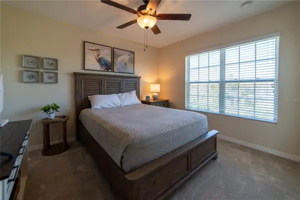 a bed sitting in a bedroom next to a window
