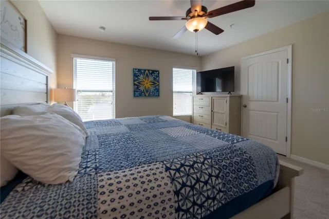 a bedroom with a bed and a chandelier