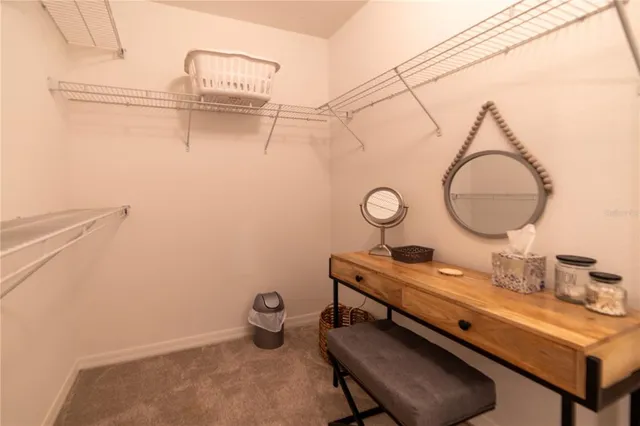 a room with a table chairs and a mirror