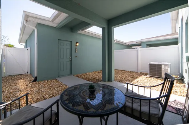 a bedroom with a table and chairs