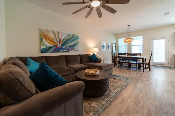 a living room with furniture and wooden floor