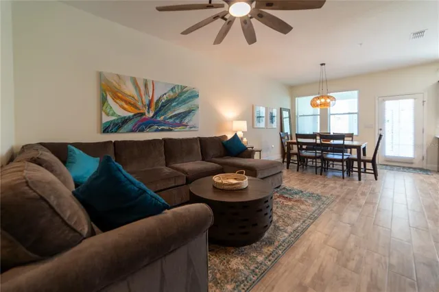 a living room with furniture and wooden floor