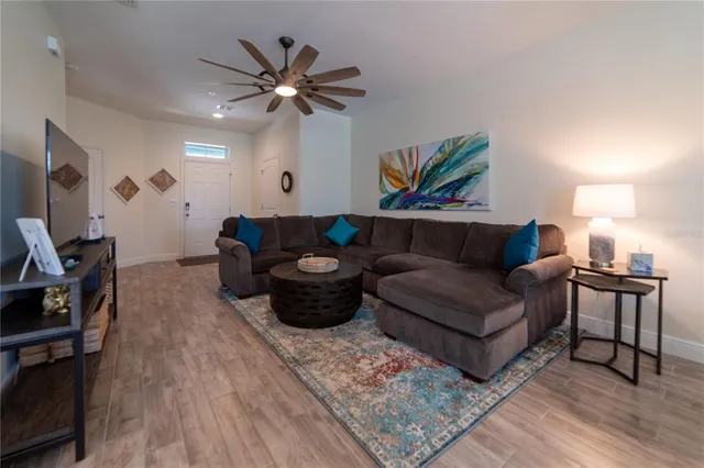 a living room with furniture and wooden floor