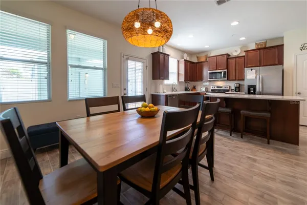 a view of a dining room with furniture and wooden floor