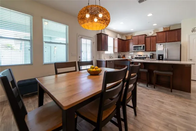 a view of a dining room with furniture and wooden floor