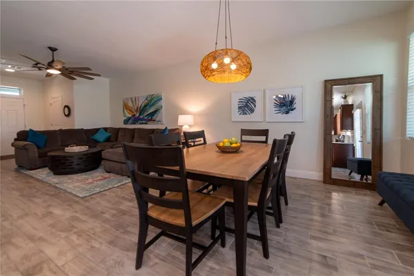 a view of a dining room with furniture and chandelier