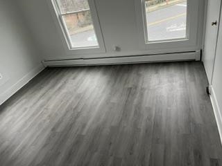 166 Rochelle Avenue, Unit 2 Rochelle Park, NJ 07662 - Photo 5 of 8 a view of a small space with wooden floor and a window