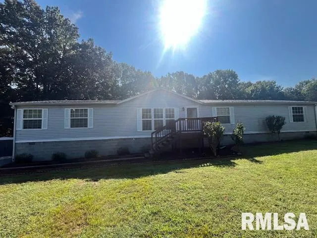 a view of a house with swimming pool next to a yard