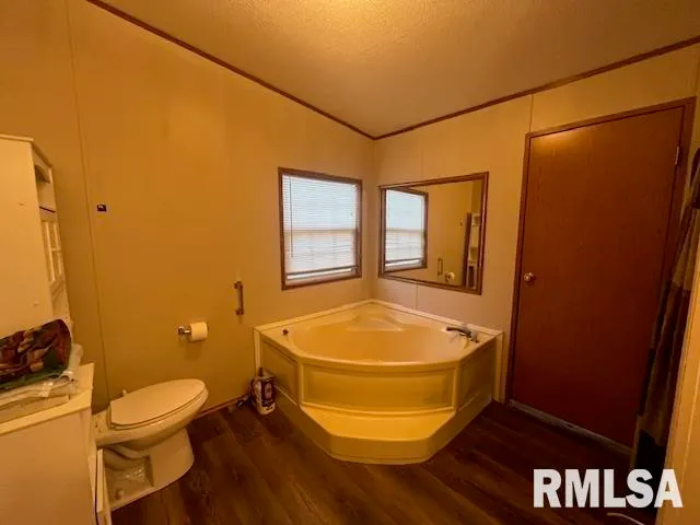 a bathroom with a tub shower and a sink