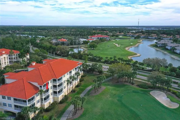 an aerial view of residential houses with outdoor space and river