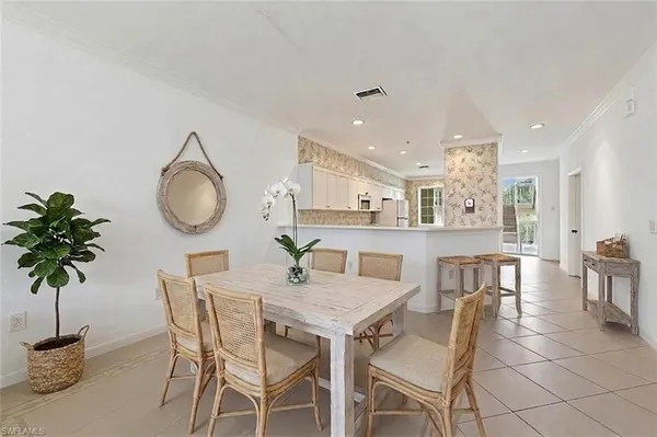 a view of a dining room with furniture and a potted plant