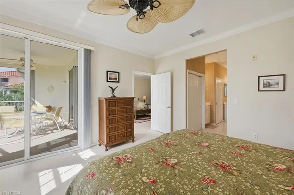 a bedroom with bed and a chandelier