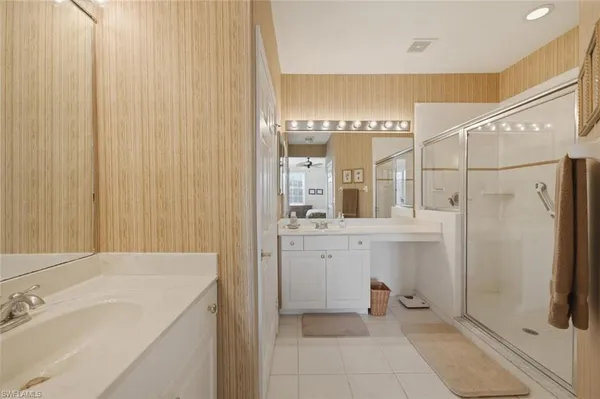 a bathroom with a sink a mirror and a shower