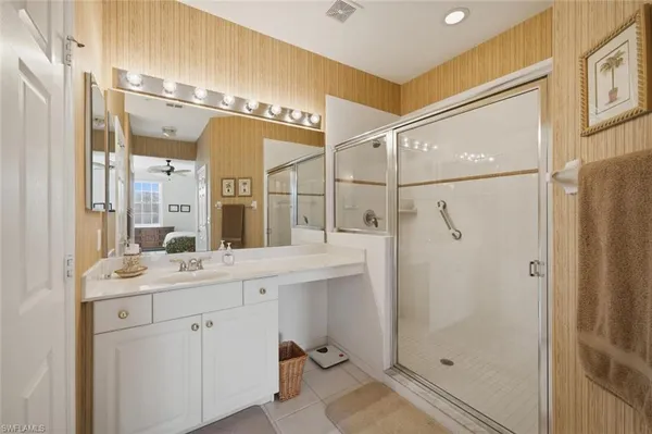 a bathroom with a shower sink and mirror