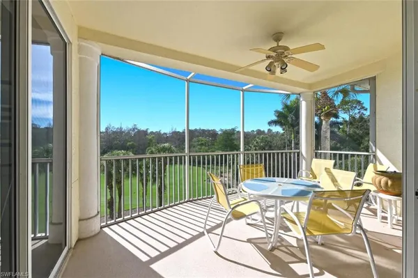a view of a balcony with chair and wooden floor