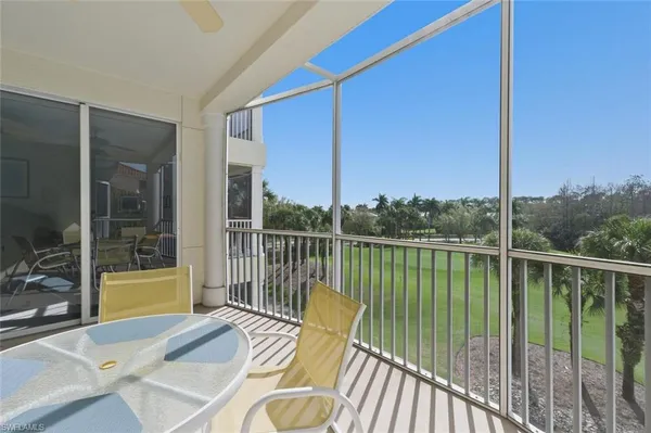 a view of a balcony with couches and wooden floor
