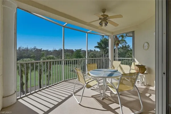 a view of a chairs and table in the balcony