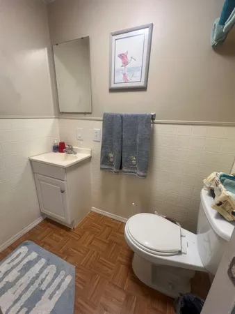a bathroom with a sink mirror vanity and toilet